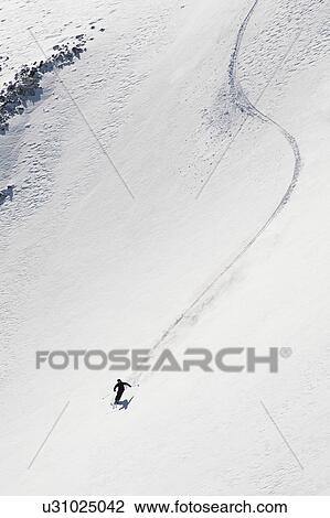 Stock Image - "Skier skiing on snow Aspen Snowmass, Aspen, Colorado, USA ". Fotosearch