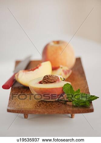 Sliced peach on chopping board View Large Photo Image Stock Photo - Sliced peach on chopping board. Fotosearch