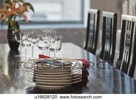 Stack of plates on table in dining room View Large Photo Image Stock Image - Stack of plates on table in dining room. Fotosearch