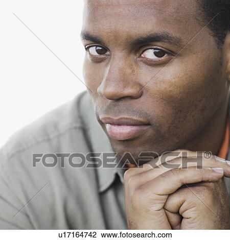 Stock Image - "Studio portrait of man, close-up". Fotosearch