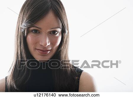 Stock Image - Studio portrait of mid-adult woman. Fotosearch