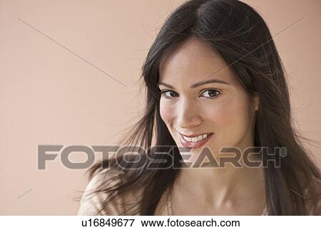 Stock Photo - Studio portrait of mid-adult woman. Fotosearch