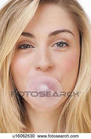 Studio portrait of young woman blowing bubble View Large Photo Image Stock Image - Studio portrait of young woman blowing bubble. Fotosearch