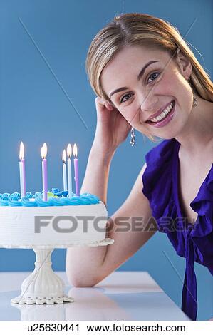 Studio portrait of young woman with birthday cake View Large Photo Image Stock Image - Studio portrait of young woman with birthday cake. Fotosearch