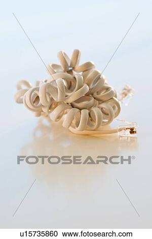 Stock Image - Studio shot of disconnected phone cord. Fotosearch