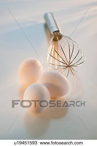 Stock Image - Studio shot of eggs and whisk. Fotosearch