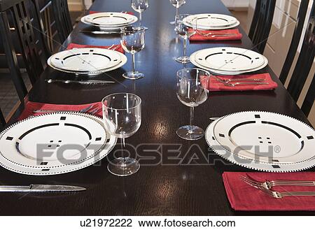 Stock Image - Table setting in dining room. Fotosearch