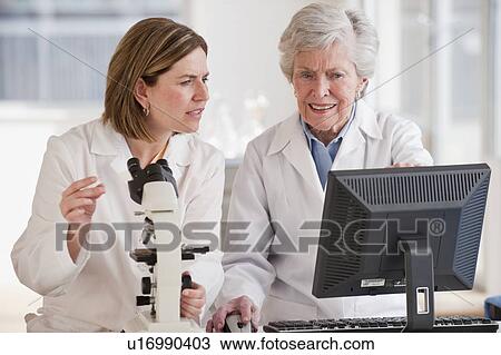 Stock Image - Two female scientists doing research. Fotosearch