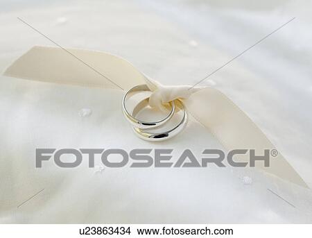 Two wedding rings tied with ribbon View Large Photo Image Picture - Two wedding rings tied with ribbon. Fotosearch