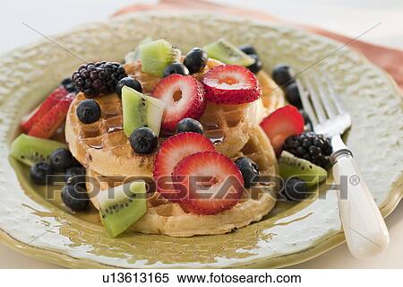 Stock Photography - Waffles with berries and kiwi on plate. Fotosearch