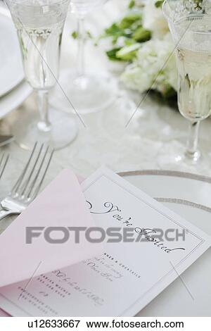 "Wedding invitation on table setting, studio shot" View Large Photo Image Stock Photo - "Wedding invitation on table setting, studio shot". Fotosearch