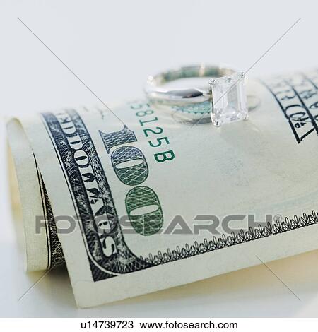 Wedding ring on one hundred dollar bill View Large Photo Image Stock Image - Wedding ring on one hundred dollar bill. Fotosearch