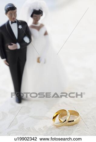 Wedding rings by bride and groom cake toppers View Large Photo Image Stock Image - Wedding rings by bride and groom cake toppers. Fotosearch