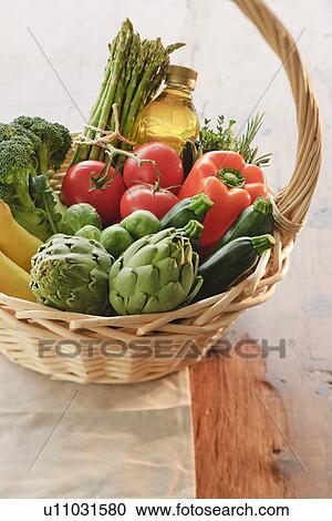Stock Image - Wicker basket filled with vegetables. Fotosearch