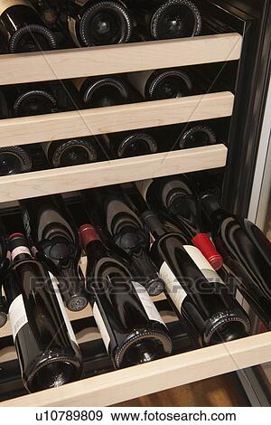 Stock Photo - Wine bottles in wine cooler. Fotosearch