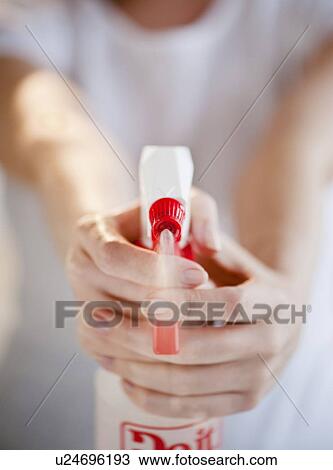 "Woman holding and spraying cleaning fluid, close-up" View Large Photo Image Stock Image - "Woman holding and spraying cleaning fluid, close-up". Fotosearch