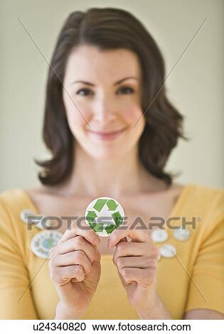 Woman holding button with recycling symbol View Large Photo Image Stock Image - Woman holding button with recycling symbol. Fotosearch