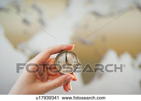 Stock Image - "Woman holding compass, close-up". Fotosearch