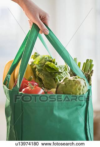 "Woman holding grocery bag, close-up" View Large Photo Image Stock Image - "Woman holding grocery bag, close-up". Fotosearch