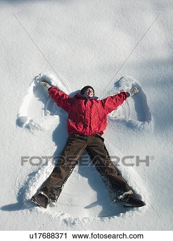 Woman making snow angel View Large Photo Image Stock Image - Woman making snow angel. Fotosearch