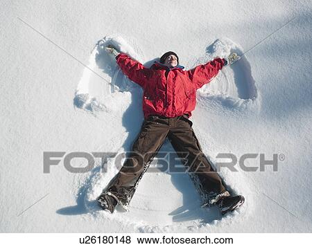 Woman making snow angel View Large Photo Image Stock Photo - Woman making snow angel. Fotosearch