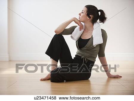 Stock Photo - "Woman relaxing after exercise, studio shot". Fotosearch