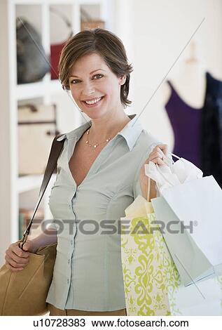 Stock Image - "Woman shopping, portrait". Fotosearch