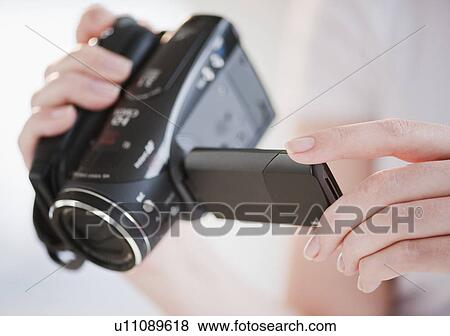 Stock Photo - "Woman using digital camcorder, close-up". Fotosearch