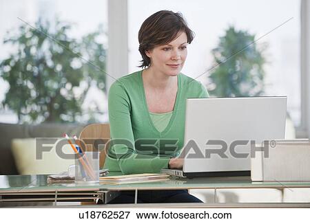 Woman using laptop View Large Photo Image Stock Photo - Woman using laptop. Fotosearch