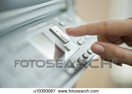 Stock Photo - "Woman using photocopier, close-up". Fotosearch