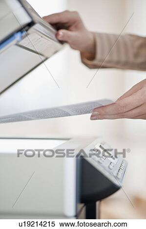 Stock Photography - "Woman using photocopier, close-up". Fotosearch