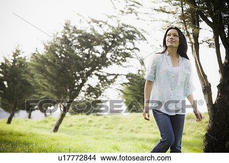 Woman walking in park View Large Photo Image Picture - Woman walking in park. Fotosearch