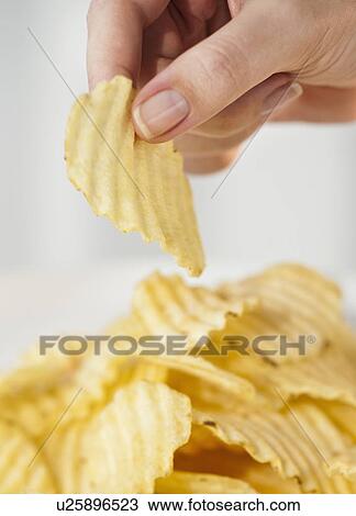 Woman's hand taking potato chip View Large Photo Image Stock Image - Woman's hand taking potato chip. Fotosearch