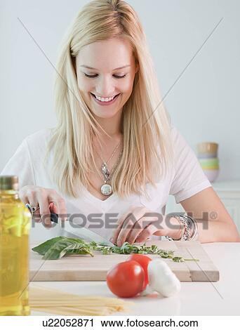Young woman chopping basil View Large Photo Image Stock Image - Young woman chopping basil. Fotosearch