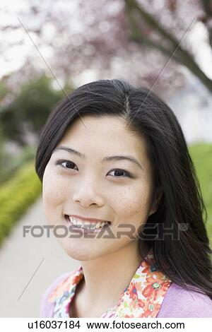 Picture - "Young woman in park, portrait". Fotosearch
