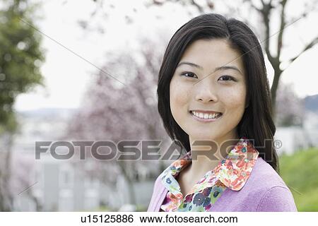 "Young woman in park, portrait" View Large Photo Image Stock Photograph - "Young woman in park, portrait". Fotosearch