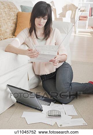 Young woman paying bills via Internet View Large Photo Image Stock Image - Young woman paying bills via Internet. Fotosearch