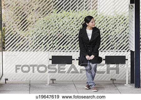 "Young woman waiting at bus stop, San Francisco, California, USA" View Large Photo Image Stock Photo - "Young woman waiting at bus stop, San Francisco, California, USA". Fotosearch