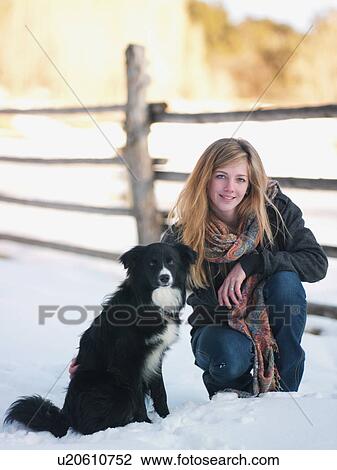 Young woman with dog on ranch View Large Photo Image Stock Image - Young woman with dog on ranch. Fotosearch