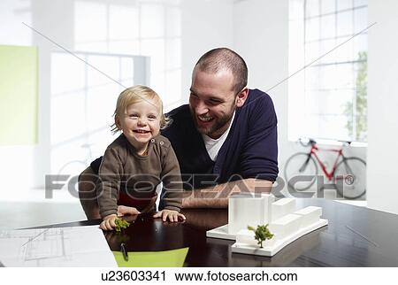 Stock Image - Architect and baby in green office. Fotosearch