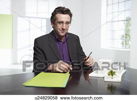 Stock Photo - Architect at work in loft office. Fotosearch
