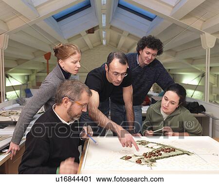 Stock Image - Architects discussing project. Fotosearch