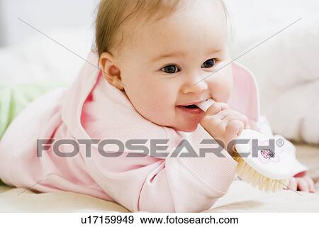 Baby holding hairbrush View Large Photo Image Stock Photo - Baby holding hairbrush. Fotosearch