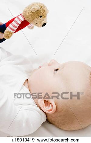 Baby looking up teddy bear View Large Photo Image Stock Photo - Baby looking up teddy bear. Fotosearch