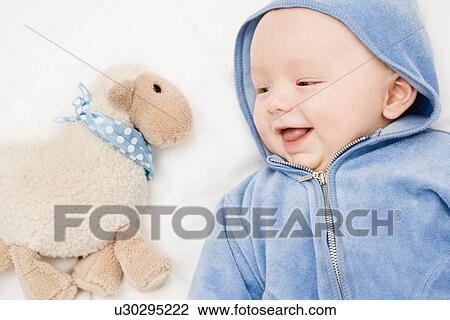 Baby smiling to a sheep View Large Photo Image Stock Image - Baby smiling to a sheep. Fotosearch