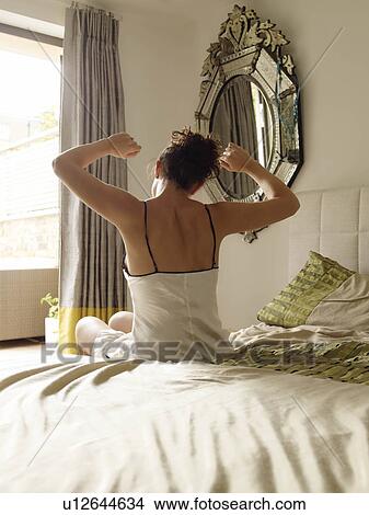 Picture - Back view of woman stretching. Fotosearch