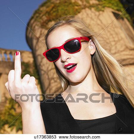 Stock Image - Blond woman giving the finger. Fotosearch