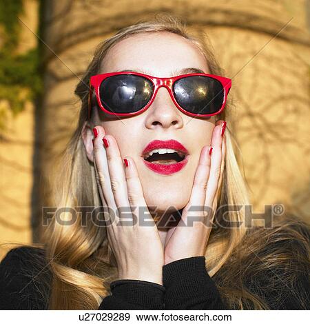 Stock Photo - Blond woman with red glasses. Fotosearch
