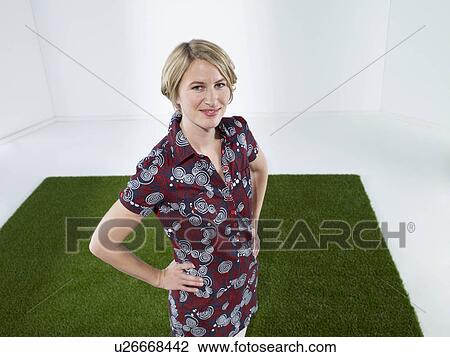 Blonde woman standing on grass View Large Photo Image Stock Image - Blonde woman standing on grass. Fotosearch