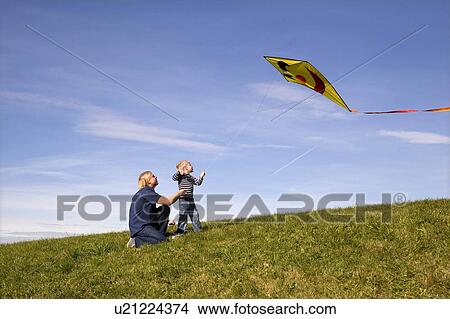 Picture - Boy and father fly a Kite. Fotosearch